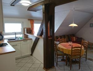 a kitchen and dining room with a table and a couch at Brosihof in Erlenbach