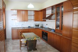 a kitchen with wooden cabinets and a table in it at Casa Annuccia in Agerola
