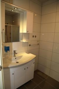 W białej łazience znajduje się umywalka i lustro. w obiekcie Siesta Garden Apart Hotel w mieście Turgutreis