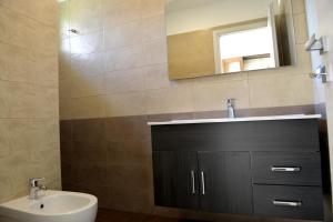 a bathroom with a sink and a mirror at Villa Sofia in Porto Cesareo +32 photos