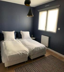 a bedroom with two beds and a window and a rug at VILLA "Le LOFT" in Wimereux