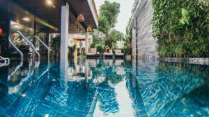 a swimming pool in front of a building at La An Central Boutique Villa in Hoi An