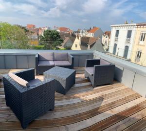 d'un balcon sur le toit avec des chaises et des tables. dans l'établissement VILLA "Le LOFT", à Wimereux