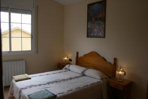 a bedroom with a bed with two lights and a window at Villa Costa. in Tossa de Mar +35 photos