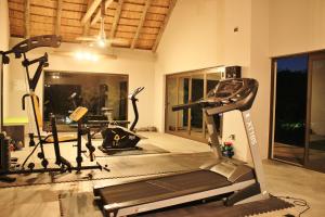 a gym with two tread machines and a treadmill at Kusudalweni Safari Lodge & Spa in Guernsey Nature Reserve
