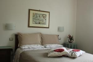 una camera con un letto con due cuscini sopra di B&B Il Giardino Di Isa a Certaldo