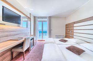 Postel nebo postele na pokoji v ubytování Hotel Panorama