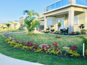 a house with a garden in front of it at The Marina Villa de Sonja in Ocho Rios