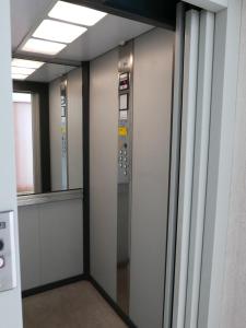 an elevator in an office building with a window at Travel Fiera in Bologna