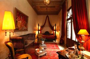 a living room with a bed and a table at Riad Ayadina & SPA in Marrakesh