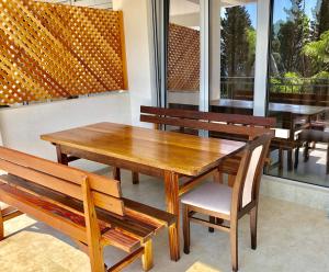 a restaurant with wooden tables and chairs and windows at Apartmani Maja in Bar