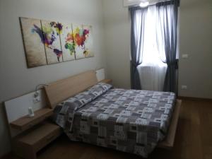 a bedroom with a bed and a window at Cooper Apartment in Genoa