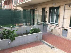 a balcony of a building with a fence and plants at Cooper Apartment in Genoa