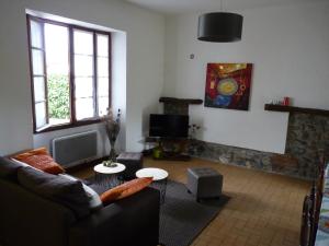 a living room with a couch and a table at Gîte altzia bas in Saint-Michel