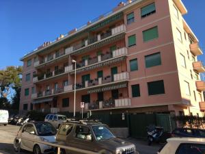a large building with cars parked in front of it at Cooper Apartment in Genoa
