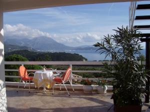 a table and chairs on a balcony with a view at Apartments Jovanic with 2 bedrooms in Sutomore
