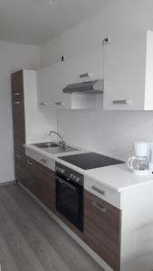 a kitchen with a sink and a stove top oven at NEW LOOK in Frankenberg