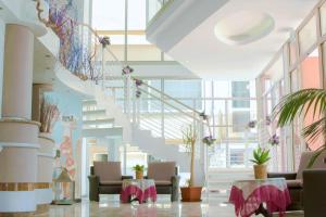 a lobby with a spiral staircase in a building at Hotel Solmar in Cattolica