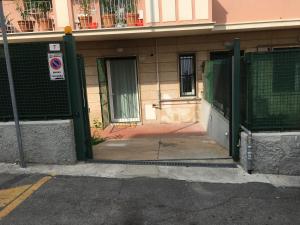 an open door to a building with a gate at Cooper Apartment in Genoa