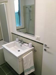 a bathroom with a white sink and a mirror at Cooper Apartment in Genoa