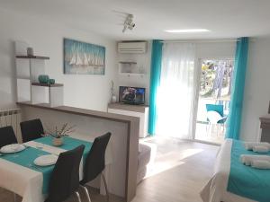 a living room with a table and a dining room at Apartment Grašo in Rab