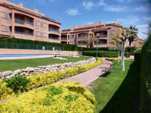 a woman sitting on a park bench in front of a building at Casa Regreso in Calafat