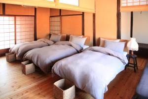 Temari Inn Oitoma tesisinde bir odada yatak veya yataklar