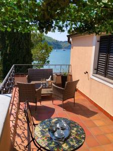 a patio with a table and chairs on a balcony at Apartment Boreas in Strunjan