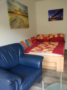 a bed and a couch in a room at Ferienappartement Trier in Trier