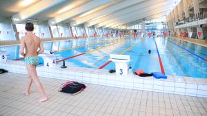 a man standing in front of a swimming pool at Dana Cup SportsCenter in Hjørring
