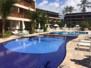 a large blue swimming pool next to a building at Nannai Beira Mar Porto de Galinhas 307 in Porto De Galinhas +45 photos