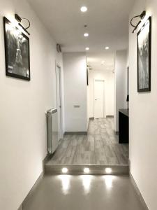 a hallway with white walls and a floor with lights at BRAKKO 45 in Naples