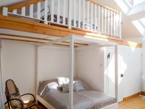 a bunk bed in a room with a loft at Living in History - Modern Country Cottage in Dudeldorf