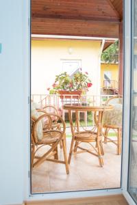 a patio with a table and chairs on a porch at Holiday Village Interpark in Kranevo