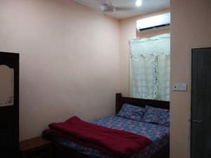 a small bedroom with a bed with a window at HOMESTAY AQILAH PASIR PUTEH KELANTAN in Pasir Puteh