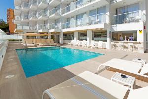 a swimming pool in the middle of a building at HSM Son Veri in El Arenal