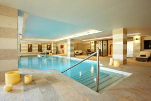 a large swimming pool in a hotel lobby at Grupotel Parc Natural & Spa in Playa de Muro