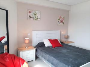 a bedroom with a bed with two night stands and two lamps at ABMAR- Por-do-sol, Vista mar, Remodelado, Wifi, 80mt Praia in Quarteira