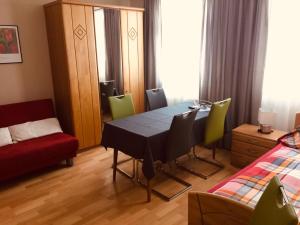 a room with a table and chairs and a bed at Gästehaus Albers in Cochem