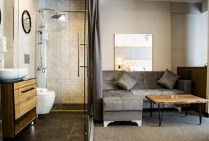 a bathroom with a couch and a table in a bathroom at Hit Suites Avcilar Hotel in Avcılar