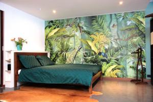 a bedroom with a tropical mural on the wall at Private Studio - FREE PARKING in Amsterdam