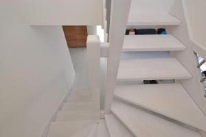a staircase in a house with white shelves at Bellarosa in Lignano Sabbiadoro