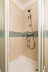 a shower with a hose in a bathroom at Apartment in pinewood near the sea in Nerezine