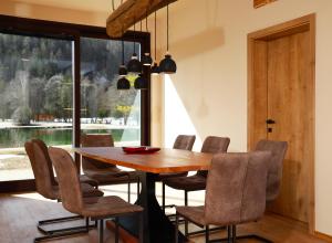 a dining room with a wooden table and chairs at Jasna Chalet Resort in Kranjska Gora