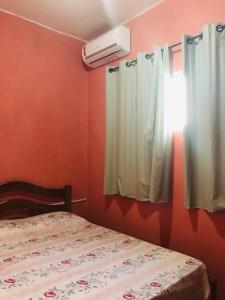 Ένα ή περισσότερα κρεβάτια σε δωμάτιο στο Casa de Veraneio Ilha de Itamaracá