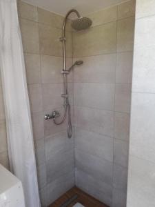 a shower with a shower head in a bathroom at Domek na Mazurach RoJo, Polska Wieś 26H in Mrągowo +72 photos