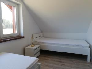 Postel nebo postele na pokoji v ubytování Domek na Mazurach RoJo, Polska Wieś 26H