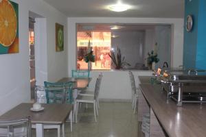 a restaurant with tables and chairs and a dining room at Hotel Monterrey in Barranquilla