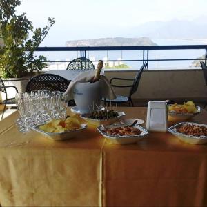 a table with plates of food and a pot on it at Hotel Villa Principe in San Nicola Arcella