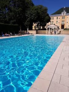 a large blue swimming pool with a gazebo at Appartement 7 Château des Gipières in Montbrun-les-Bains +2 photos